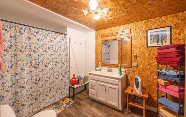 bathroom with hardwood / wood-style floors, vanity, a shower with curtain, toilet, and a chandelier