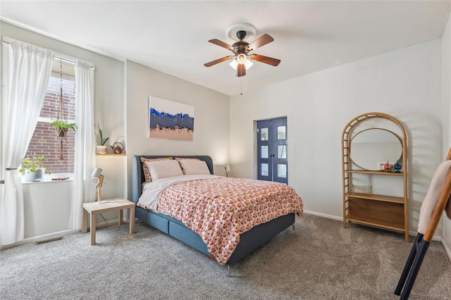 bedroom with visible vents, carpet flooring, baseboards, and ceiling fan