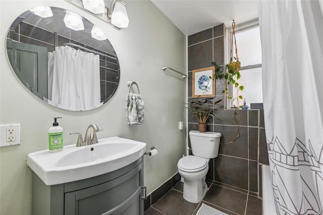 bathroom with tile patterned floors, a shower with curtain, toilet, baseboards, and vanity