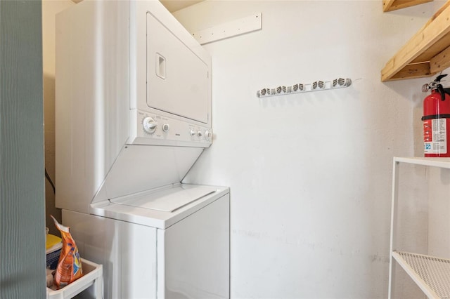 clothes washing area with laundry area and stacked washer / dryer