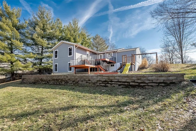 rear view of property with a lawn and a playground