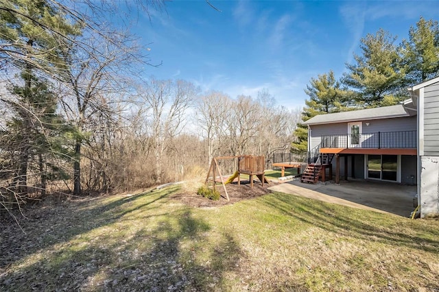 view of yard with a wooden deck and a patio