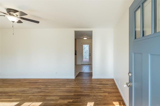 spare room with ceiling fan and dark hardwood / wood-style flooring