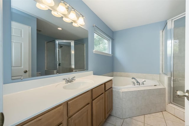 bathroom featuring tile patterned flooring, vanity, and shower with separate bathtub