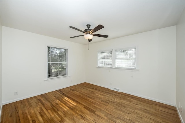 empty room featuring hardwood / wood-style flooring and ceiling fan