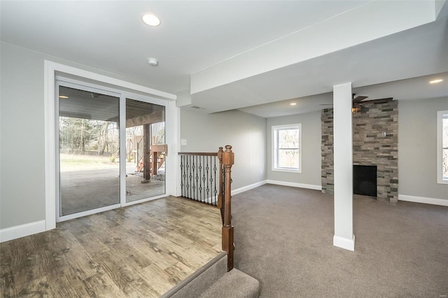 interior space with ceiling fan, hardwood / wood-style floors, and a fireplace