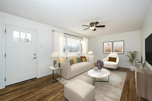 living room with ceiling fan and dark hardwood / wood-style floors