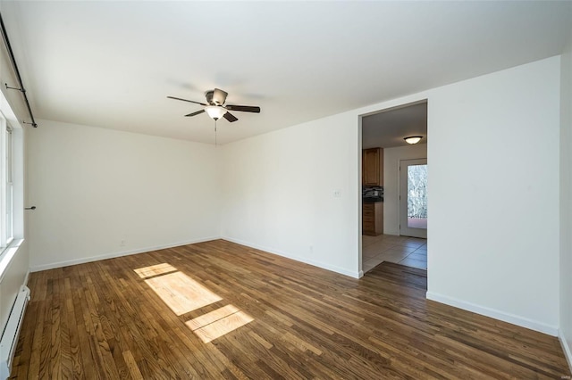 spare room with ceiling fan, dark hardwood / wood-style floors, and baseboard heating