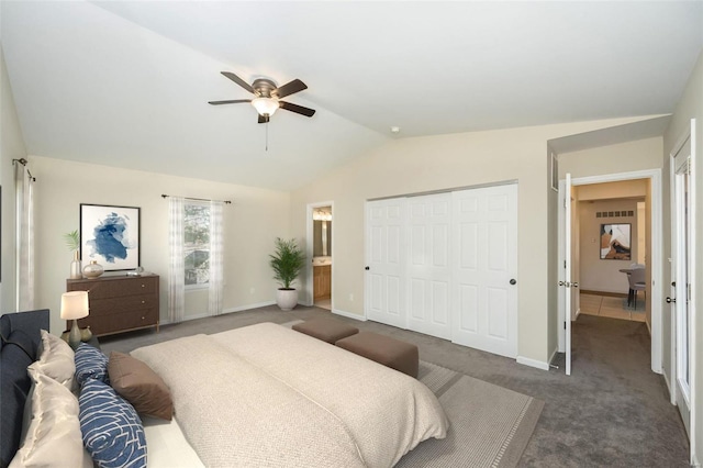 carpeted bedroom with connected bathroom, vaulted ceiling, a closet, and ceiling fan