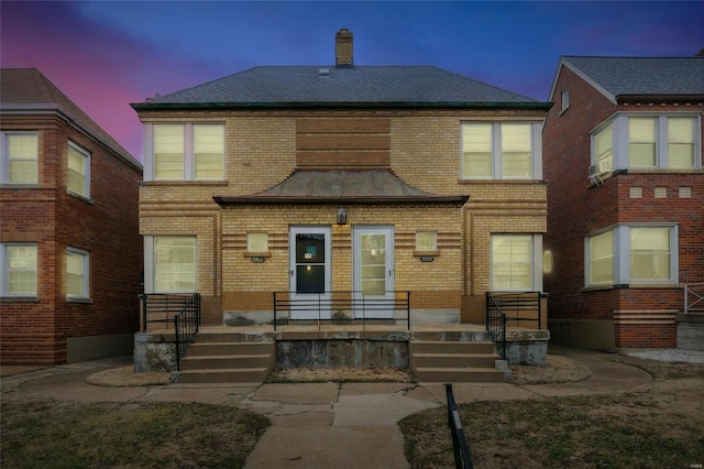 view of back house at dusk