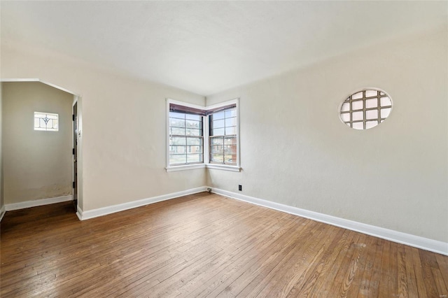 unfurnished room with hardwood / wood-style flooring