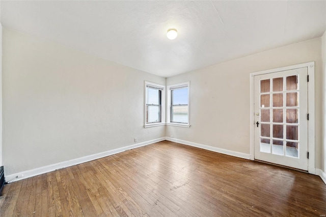 unfurnished room featuring hardwood / wood-style flooring