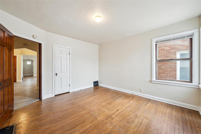 unfurnished room featuring light hardwood / wood-style floors