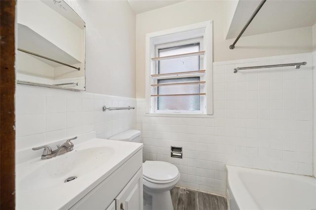 bathroom featuring vanity, toilet, hardwood / wood-style floors, and tile walls