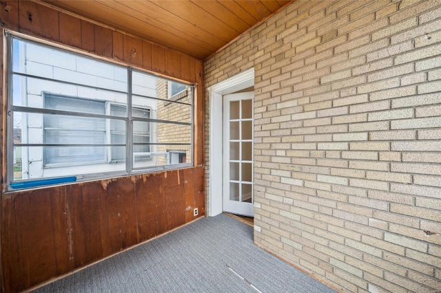 unfurnished sunroom featuring wooden ceiling