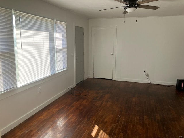 empty room with dark hardwood / wood-style floors and ceiling fan