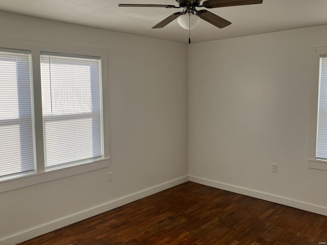 spare room with ceiling fan and dark hardwood / wood-style flooring