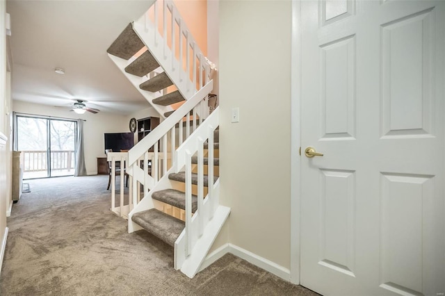 stairs featuring carpet flooring, baseboards, and a ceiling fan