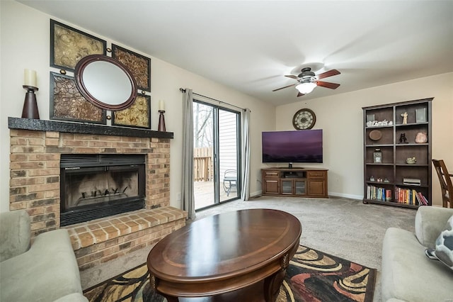 carpeted living area with a fireplace, a ceiling fan, and baseboards