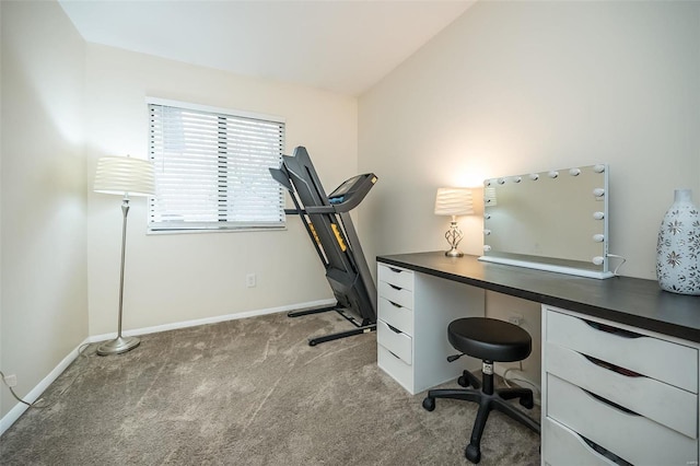 home office with light carpet, lofted ceiling, and baseboards