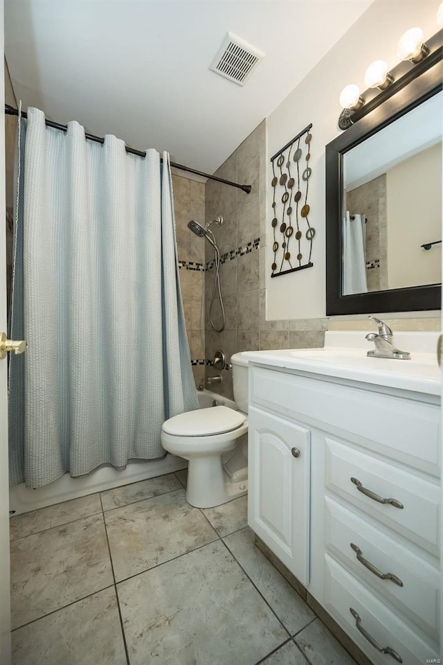 full bath featuring toilet, visible vents, shower / bath combo with shower curtain, tile patterned flooring, and vanity