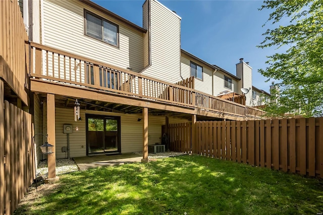 rear view of house with fence private yard, a yard, central air condition unit, and a deck