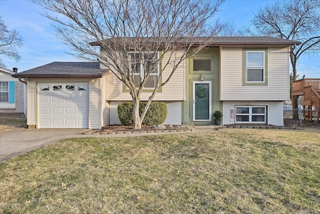 raised ranch with a garage and a front lawn