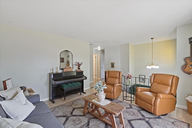 living room featuring a notable chandelier and light hardwood / wood-style floors