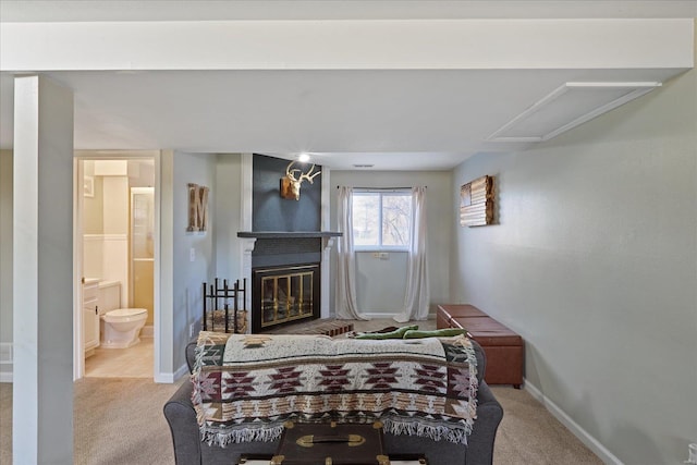 carpeted bedroom featuring a fireplace and ensuite bath