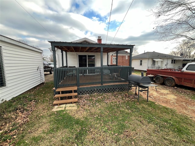 rear view of property featuring a yard