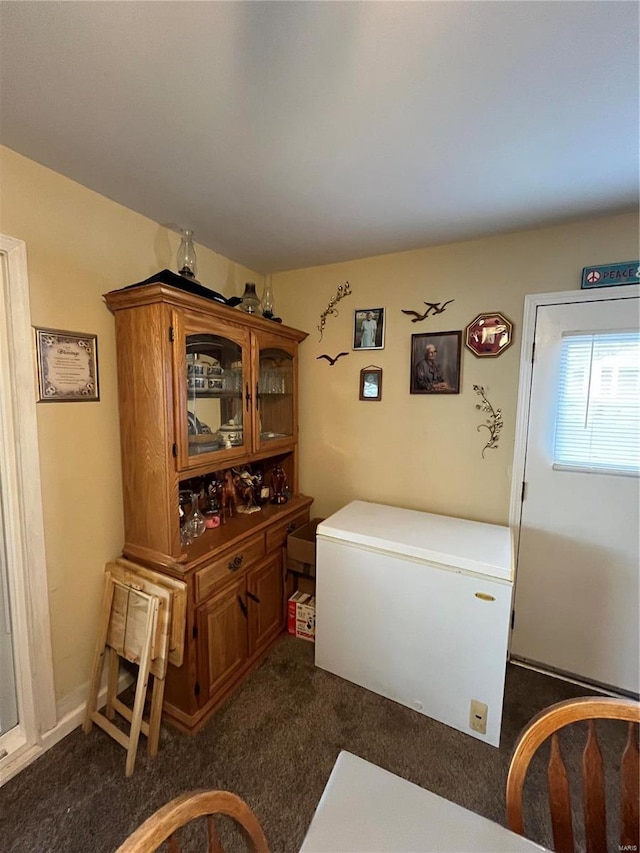 dining room with dark colored carpet