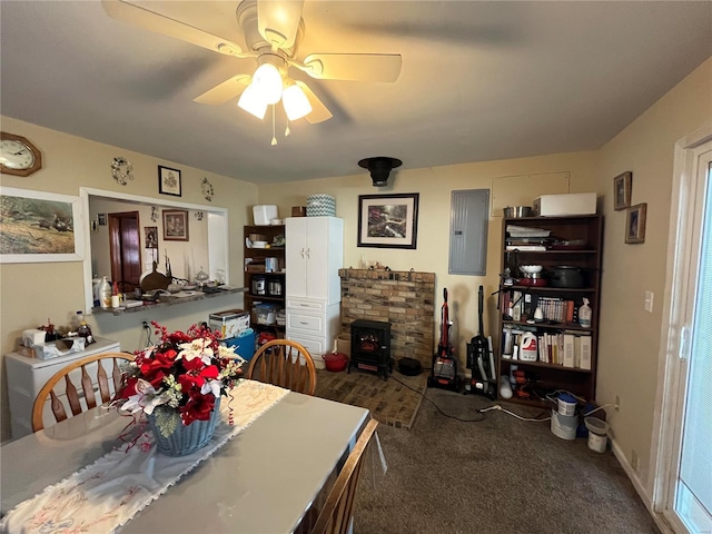 dining space with dark carpet, electric panel, ceiling fan, and a wood stove