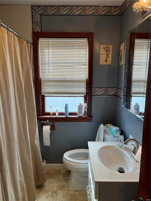 bathroom featuring tile patterned flooring, vanity, and toilet