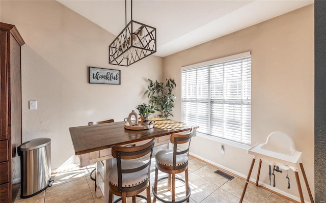 tiled dining room with vaulted ceiling