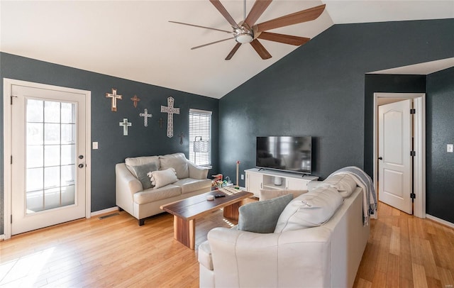 living room featuring vaulted ceiling, ceiling fan, and light hardwood / wood-style floors