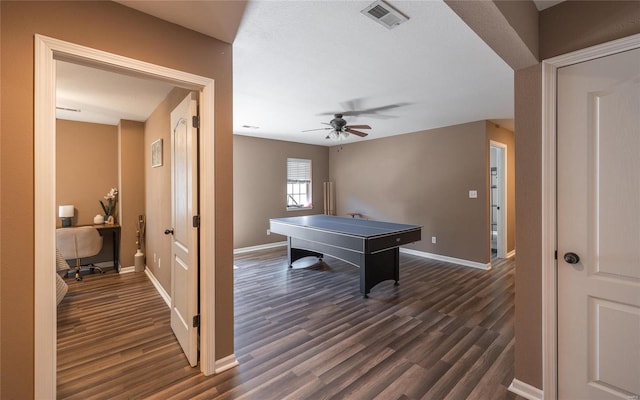 recreation room with ceiling fan and dark hardwood / wood-style flooring