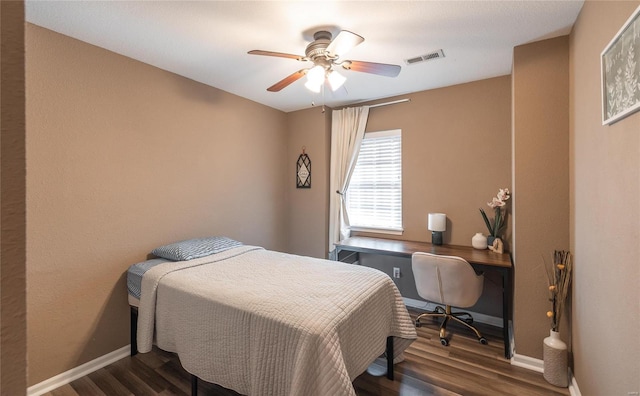 bedroom with ceiling fan and dark hardwood / wood-style flooring