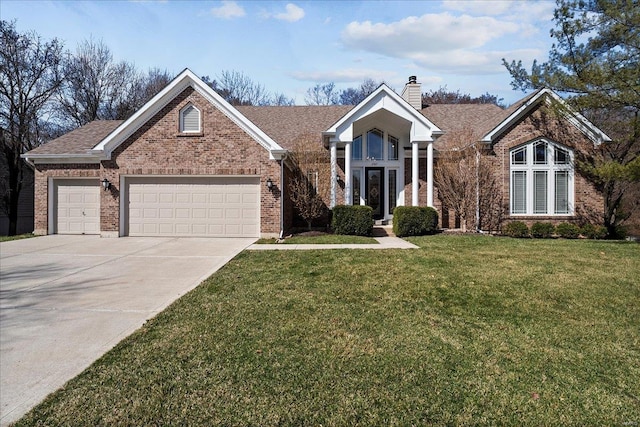 view of front of home with an attached garage, a chimney, a front lawn, concrete driveway, and brick siding