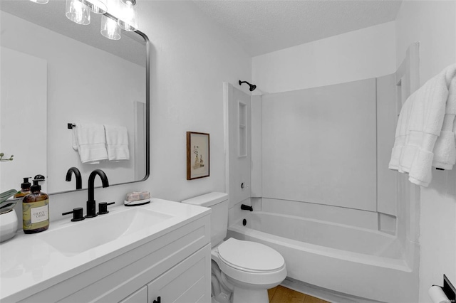 full bathroom featuring vanity, shower / washtub combination, a textured ceiling, and toilet