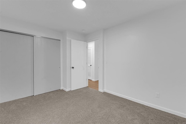 unfurnished bedroom featuring carpet and a closet