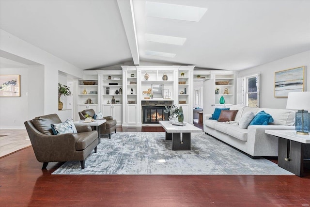 living area featuring lofted ceiling with skylight, a fireplace with flush hearth, and wood finished floors