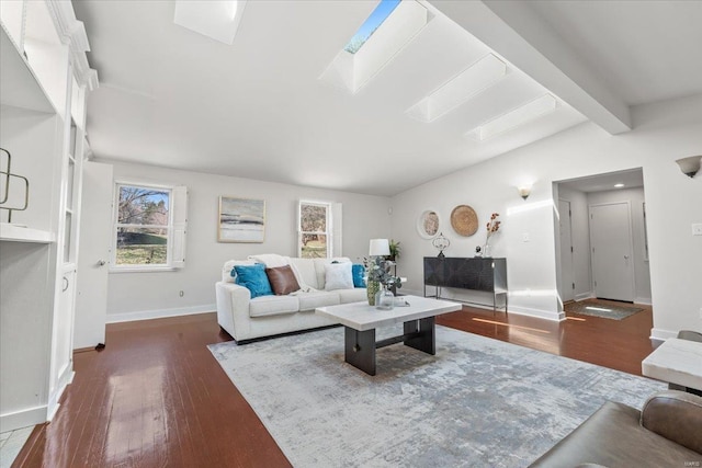 living room featuring lofted ceiling with beams, wood finished floors, and baseboards