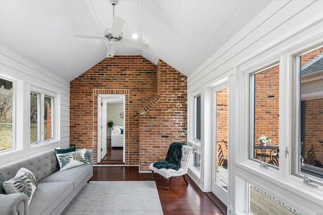 sunroom with lofted ceiling, wood ceiling, and a ceiling fan