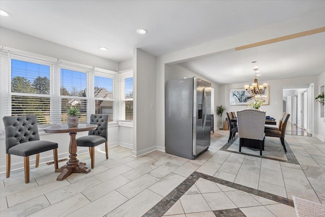 dining room with an inviting chandelier, recessed lighting, and baseboards