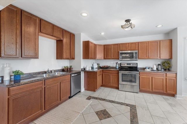 kitchen featuring a sink, recessed lighting, brown cabinets, and stainless steel appliances