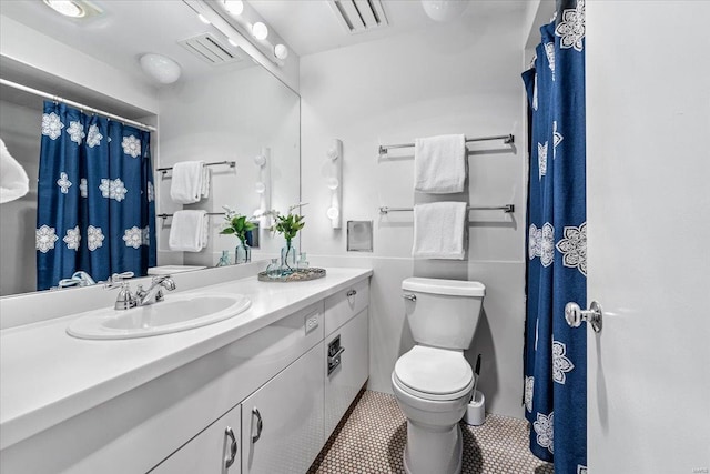 full bathroom featuring visible vents, toilet, vanity, and tile patterned flooring