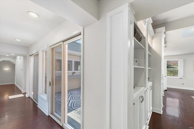 hallway with dark wood-type flooring, recessed lighting, and baseboards