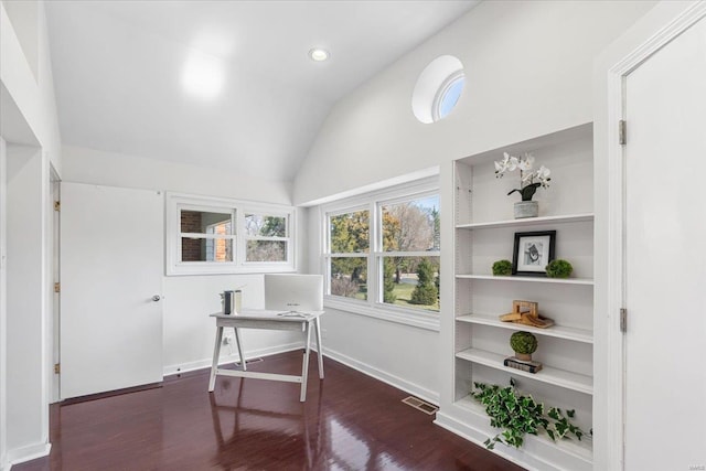 home office with visible vents, dark wood-style flooring, lofted ceiling, and built in features