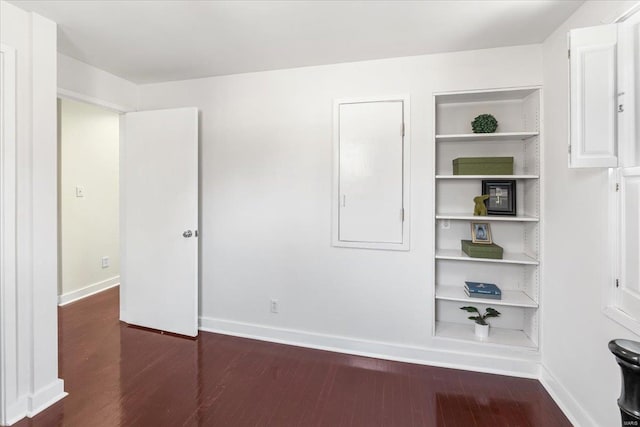 unfurnished bedroom featuring baseboards and wood finished floors