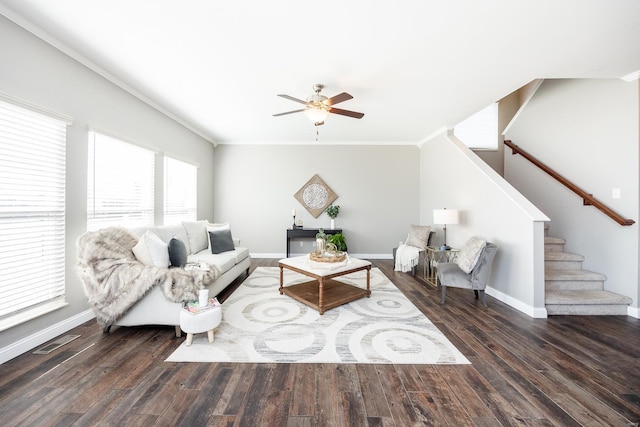 living room with crown molding, dark hardwood / wood-style floors, and ceiling fan